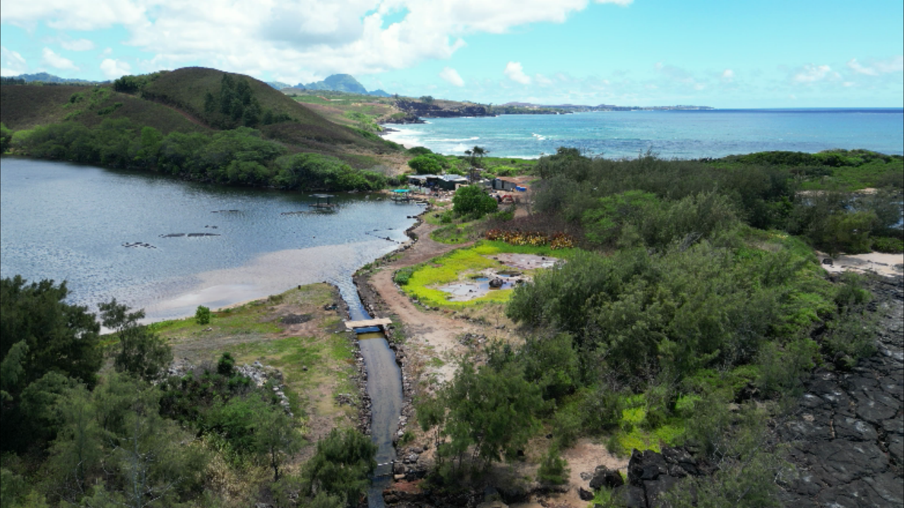 Nōmilu Fishpond, its ocean channel, and the Kauaʻi coastline